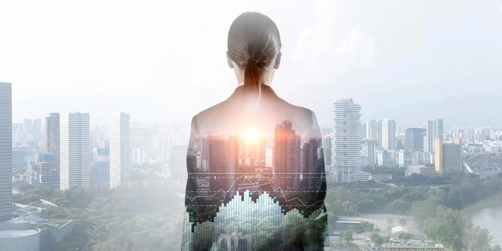young executive woman standing in front of a cityscape